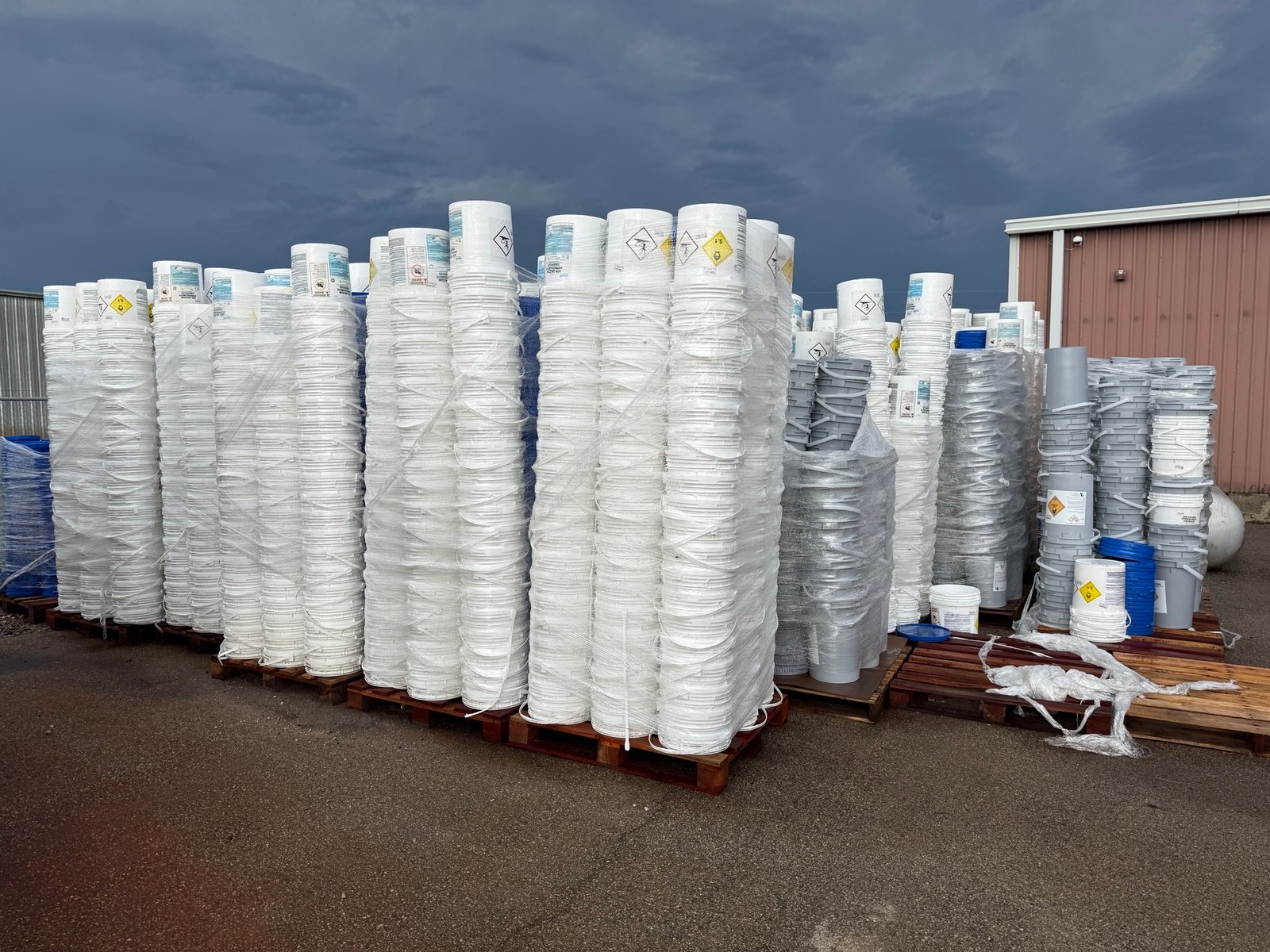 Palletized wholesale 5 gallon white buckets in warehouse